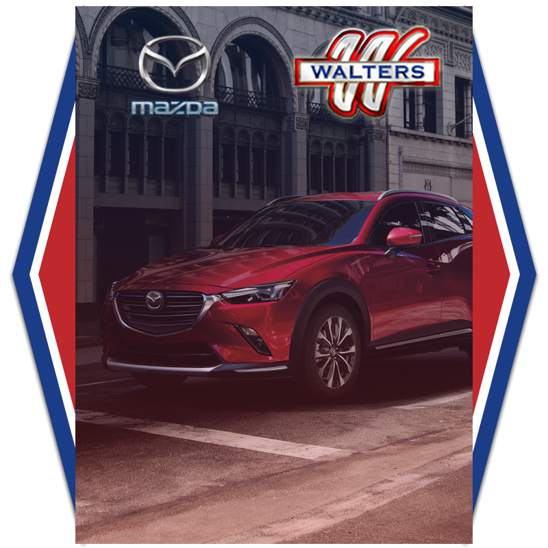 Red Mazda SUV in urban setting Walters dealership