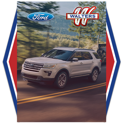 Ford SUV driving through trees Walters dealership